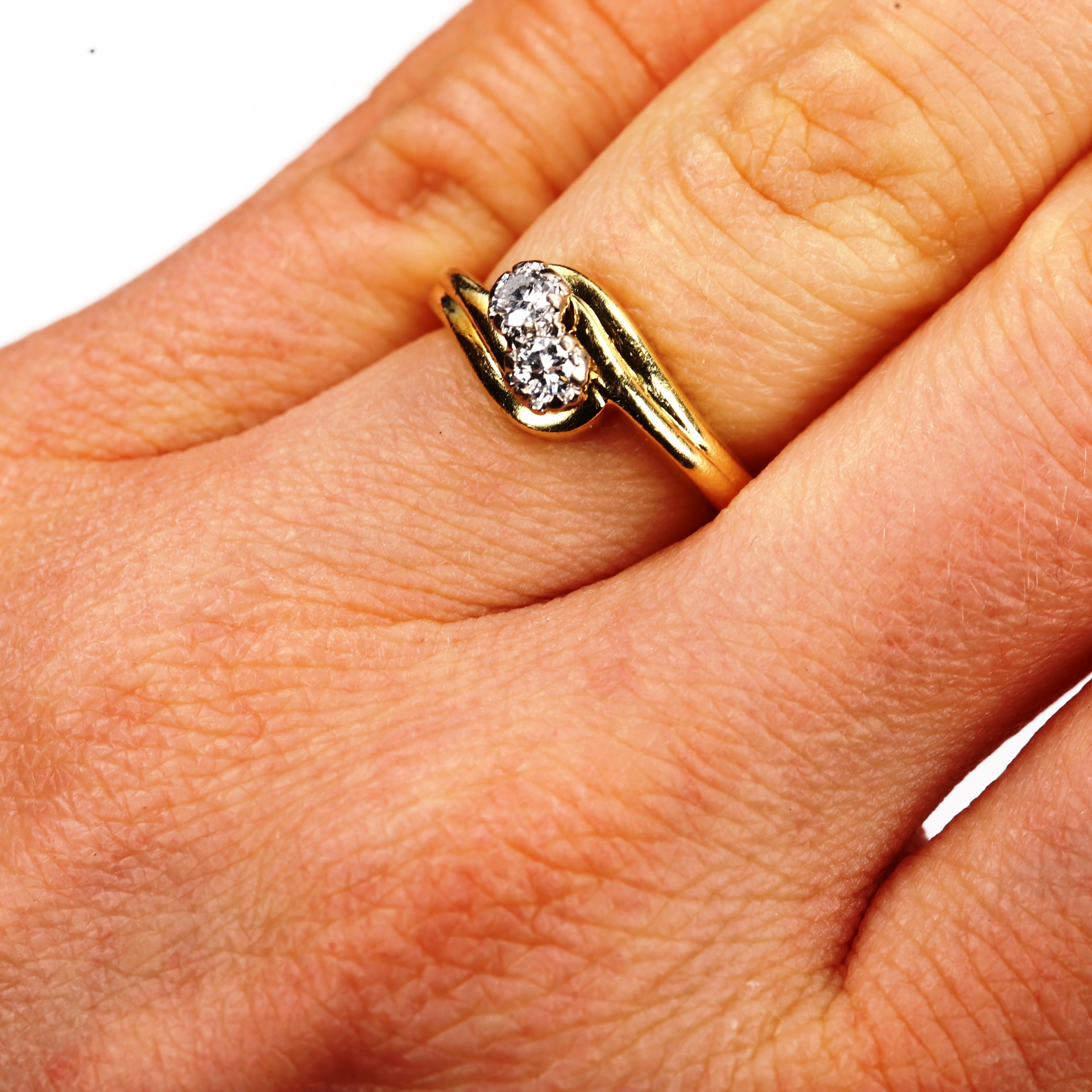 A modern 18ct gold two stone diamond crossover ring, set with modern round brilliant-cut diamonds, - Image 4 of 4