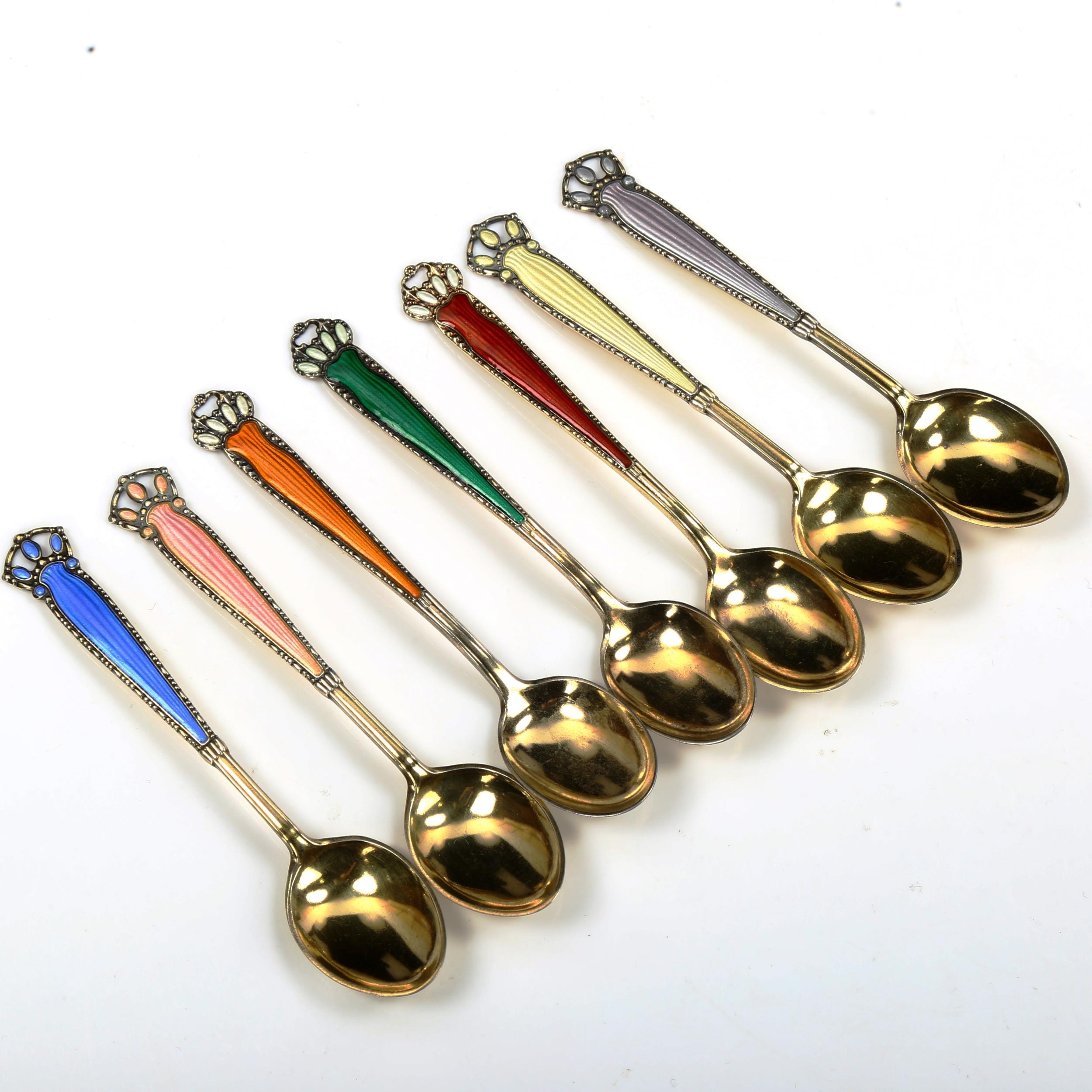 A set of 7 Norwegian vermeil sterling silver and harlequin enamel coffee spoons, length 10cm No