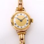 A lady's early 20th century 9ct gold mechanical bracelet watch, champagne dial with silvered chapter