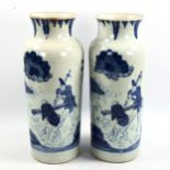 A pair of Chinese blue and white porcelain cylinder vases, hand painted scenes with text