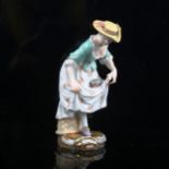 A Meissen porcelain figure of a country girl with a bird in her dress, height 12cm