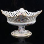 Porcelain table centre fruit bowl, with pierced sides and painted botanical designs, length 33cm