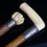 A Japanese ivory-handled netsuke, depicting man faces, and an ivory and silver-handled walking stick