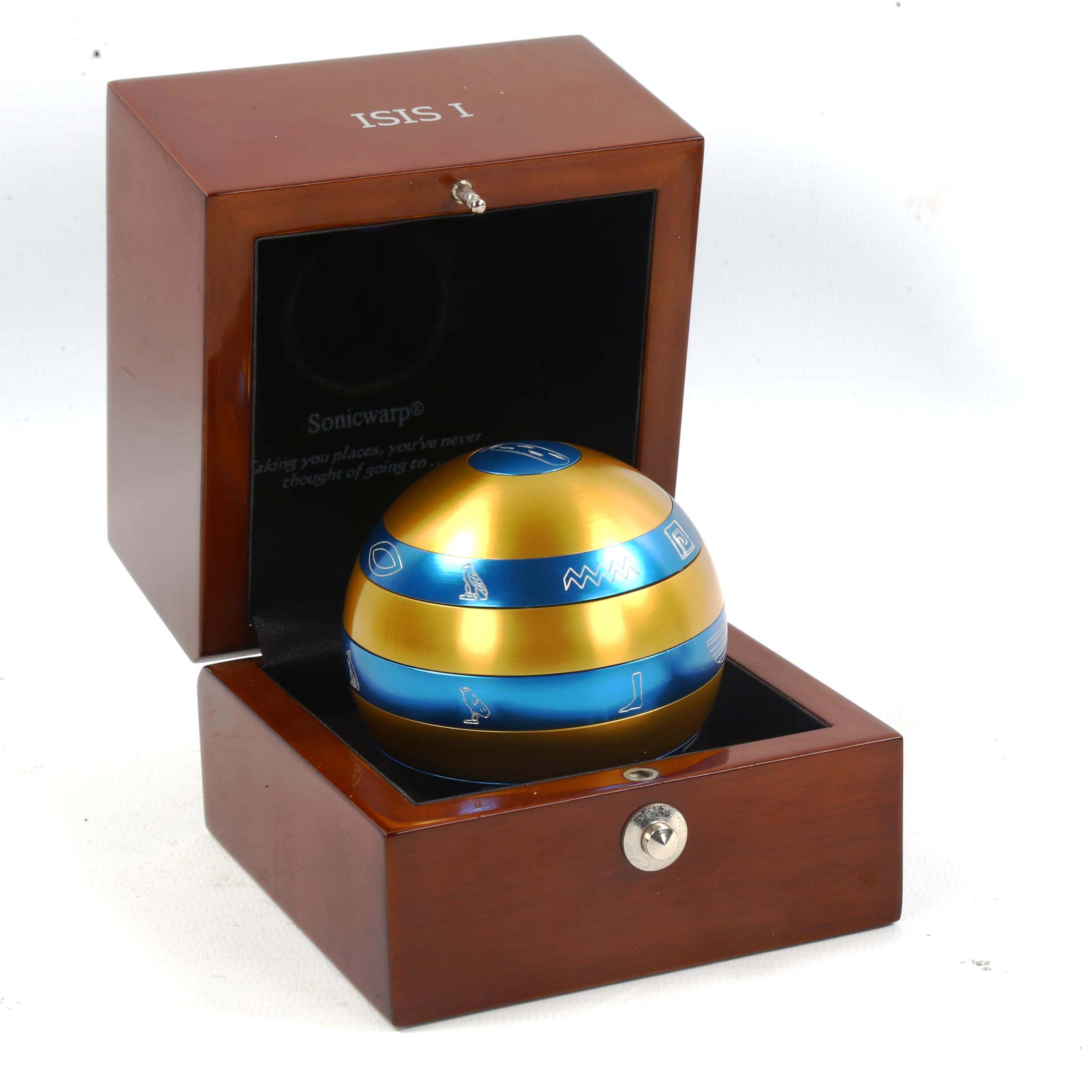 An Isis puzzle ball in original wooden case, diameter 7cm