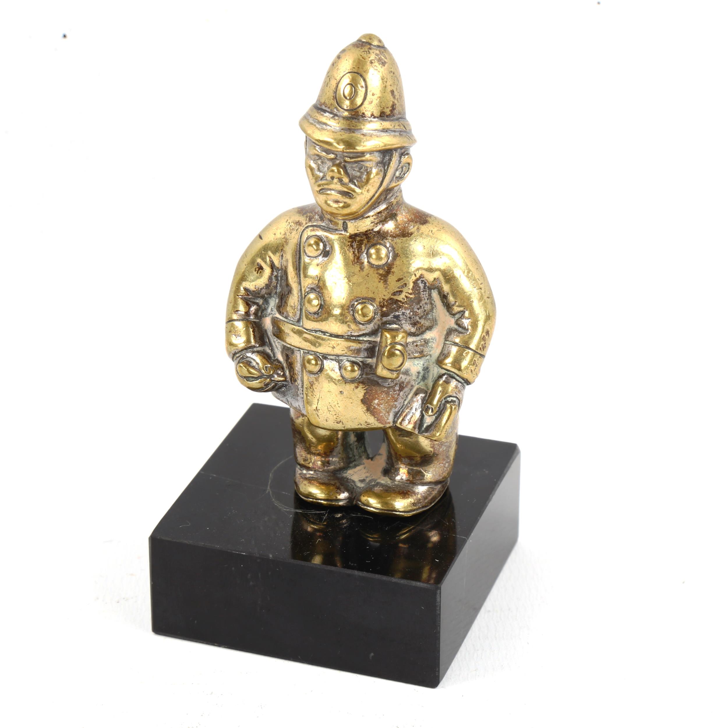 A Vintage brass policeman design car mascot, modern black glass stand, overall height 10cm