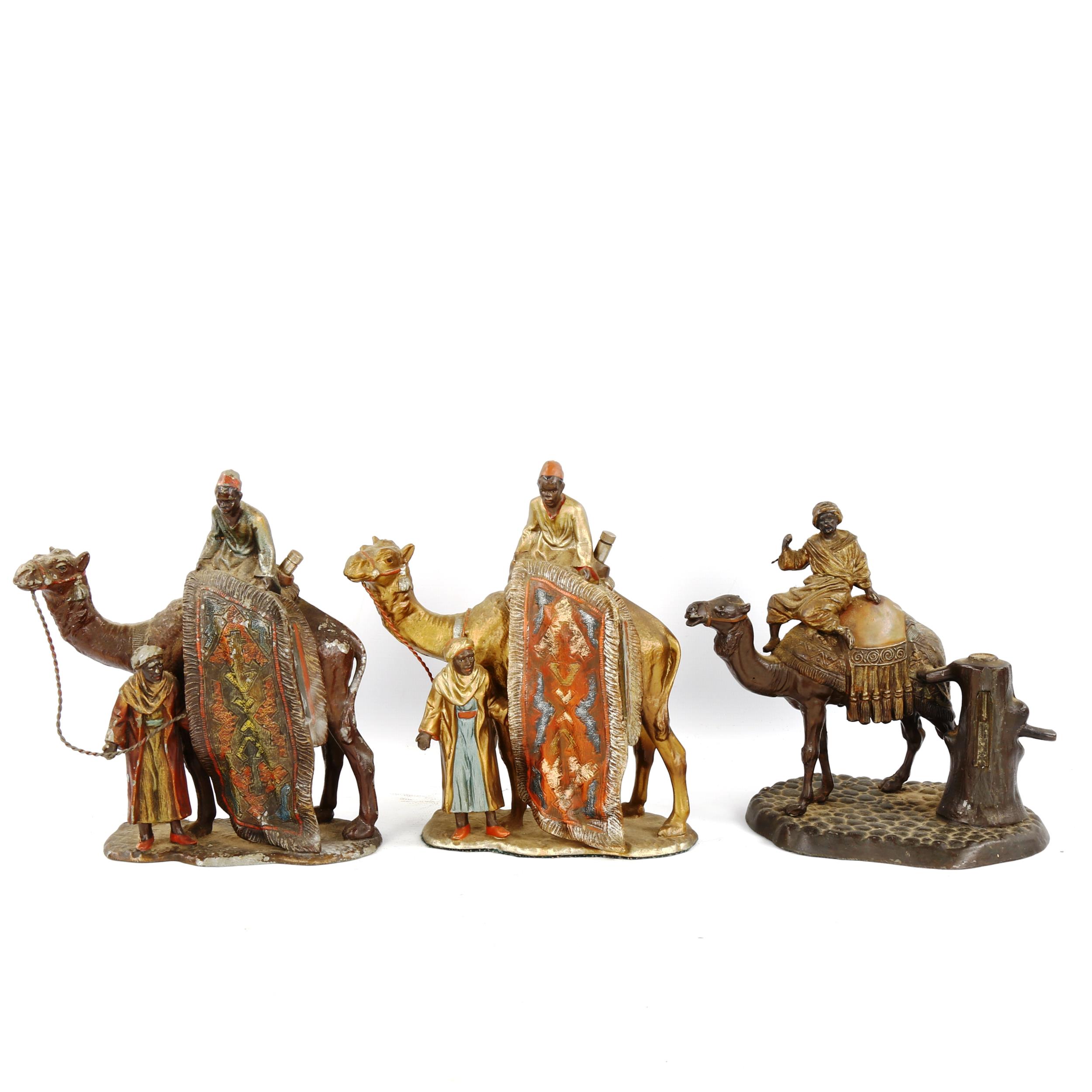 3 Austrian cold painted spelter table lighters, in the form of a camel and rider, height 16cm