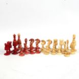 A 19th century red and white stained bone chess set, King height 8cm, in original poker-work