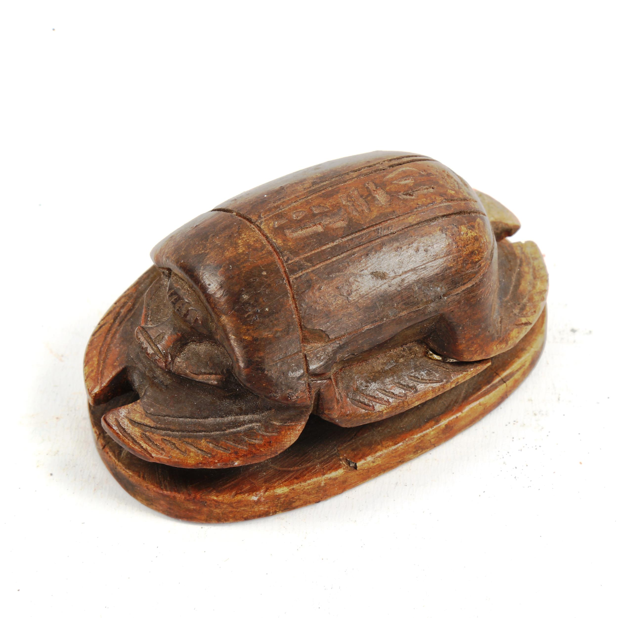 An Egyptian carved stone scarab beetle, length 9.5cm