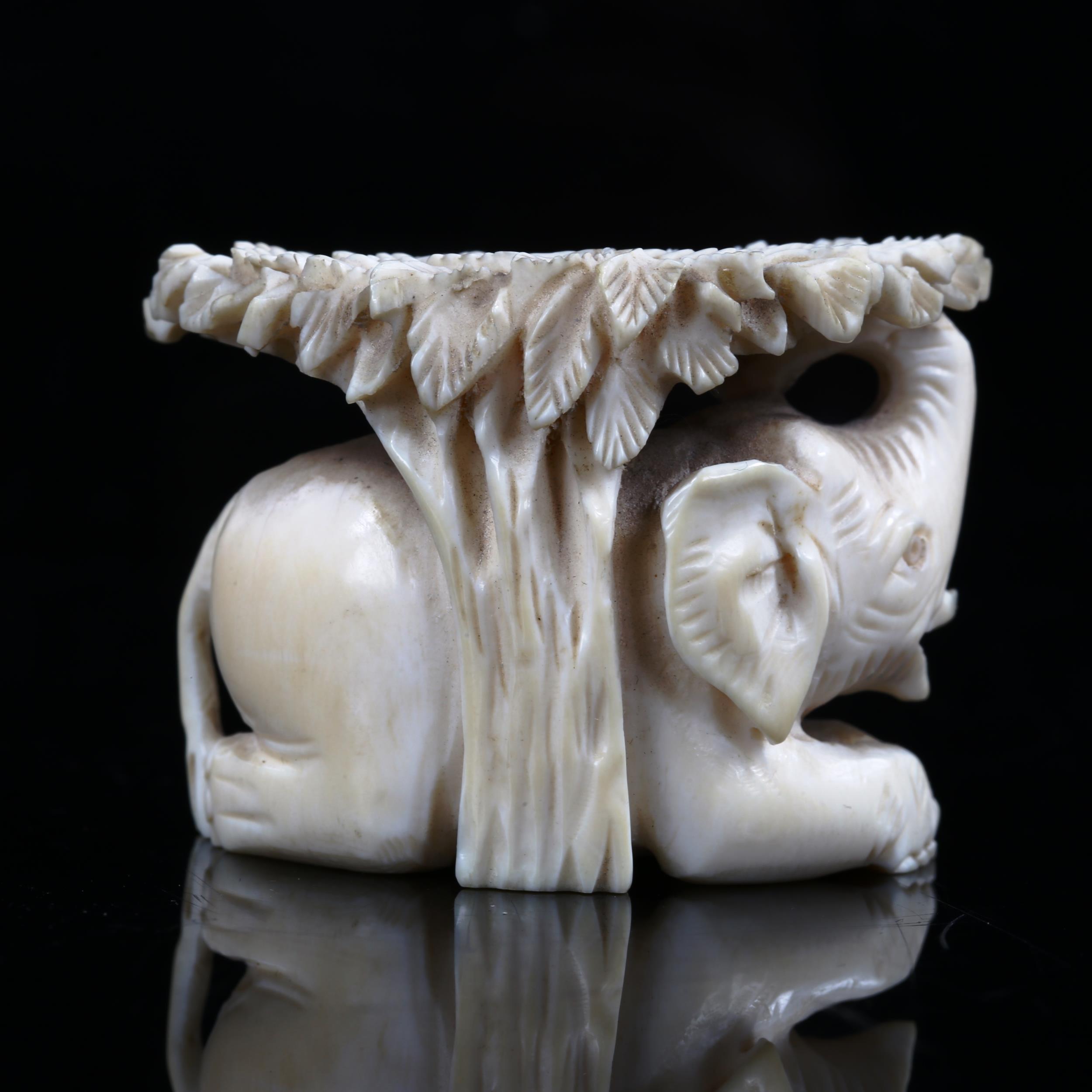 A 19th century ivory carving depicting an elephant sheltering under a tree, length 4.5cm - Image 4 of 5