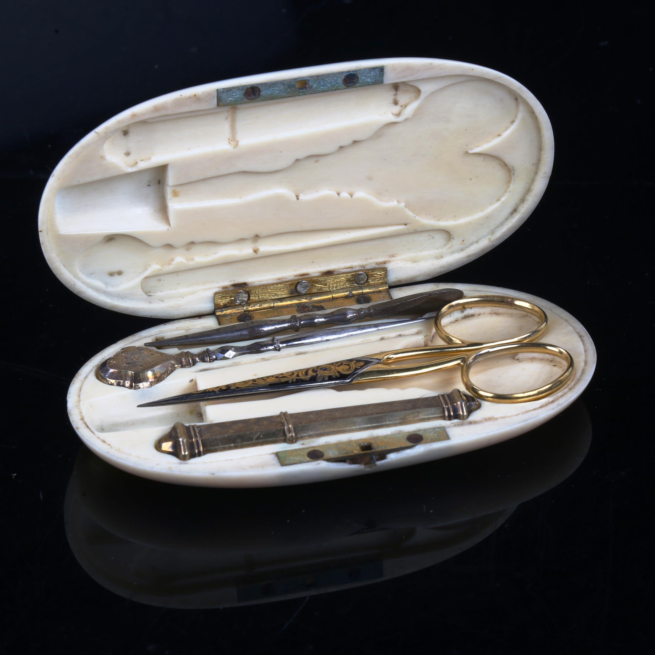 A 19th century ivory sewing etui, containing gilded scissors, needle case etc, case length 11cm