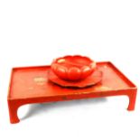 A Japanese gilded red lacquer tray on bracket feet, length 57cm, and a red lacquer lotus flower