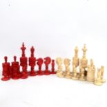 A 19th century red and white stained bone chess set, King height 13cm