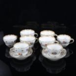 A group of Meissen porcelain cups and saucers, hand painted botanical designs