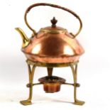 An Arts and Crafts copper and brass tea kettle on stand, with wicker handle