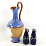 A Royal Doulton ewer with relief Jockey plaque and two Doulton bottles, tallest 29cm Good condition.