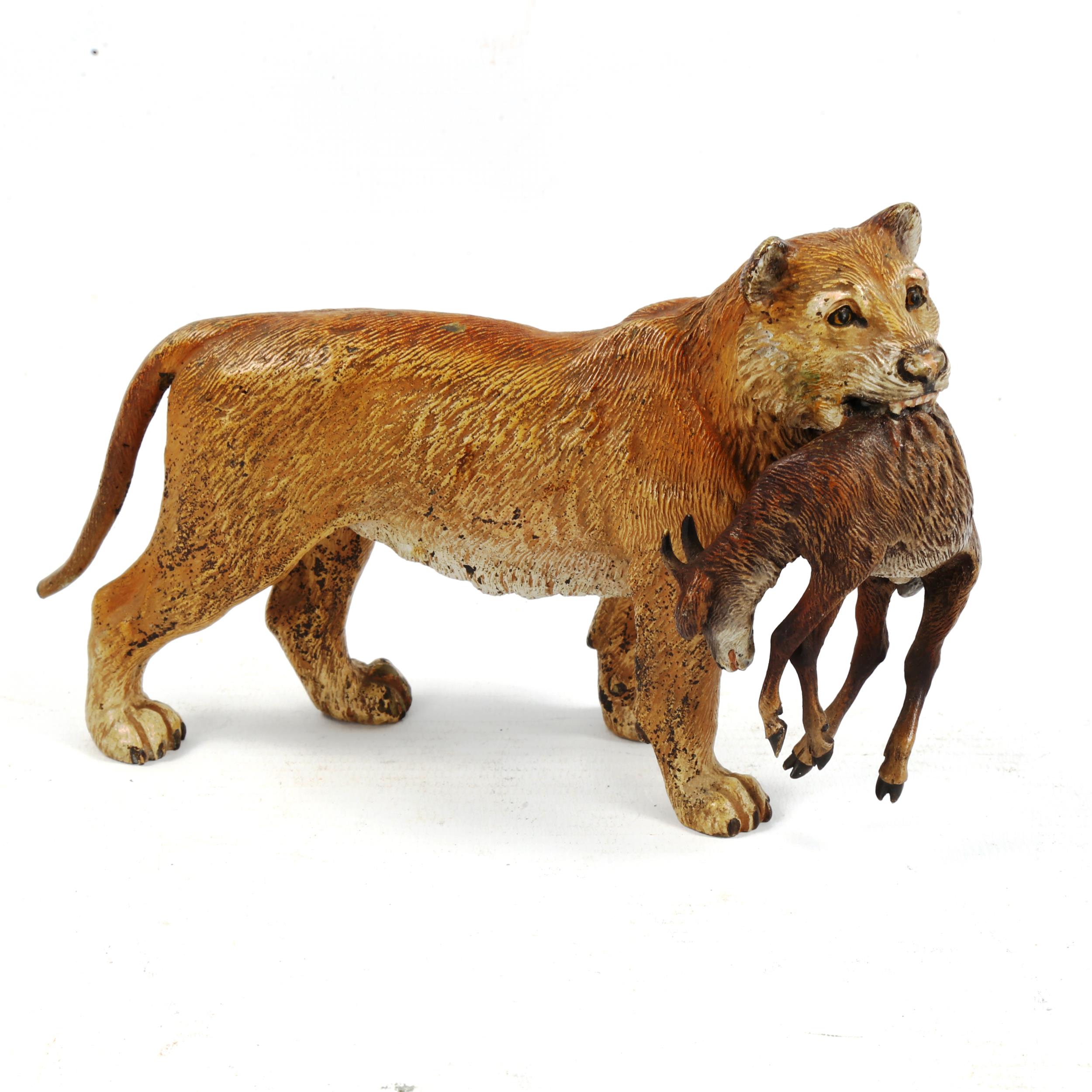 An Austrian cold painted bronze lioness carrying an antelope, length 17cm