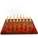 A 19th century red and white stained bone chess set, King height 12cm (1 red pawn not matching),