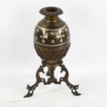 An Islamic brass lamp base, with silver inlaid decoration on cast stand, height 22cm