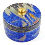 CARLTON WARE - a blue lustre cylindrical pot and cover, circa 1930, with gilded trees, diameter 14cm