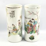A pair of Chinese white glaze cylindrical porcelain vases, with painted garden scenes and text,