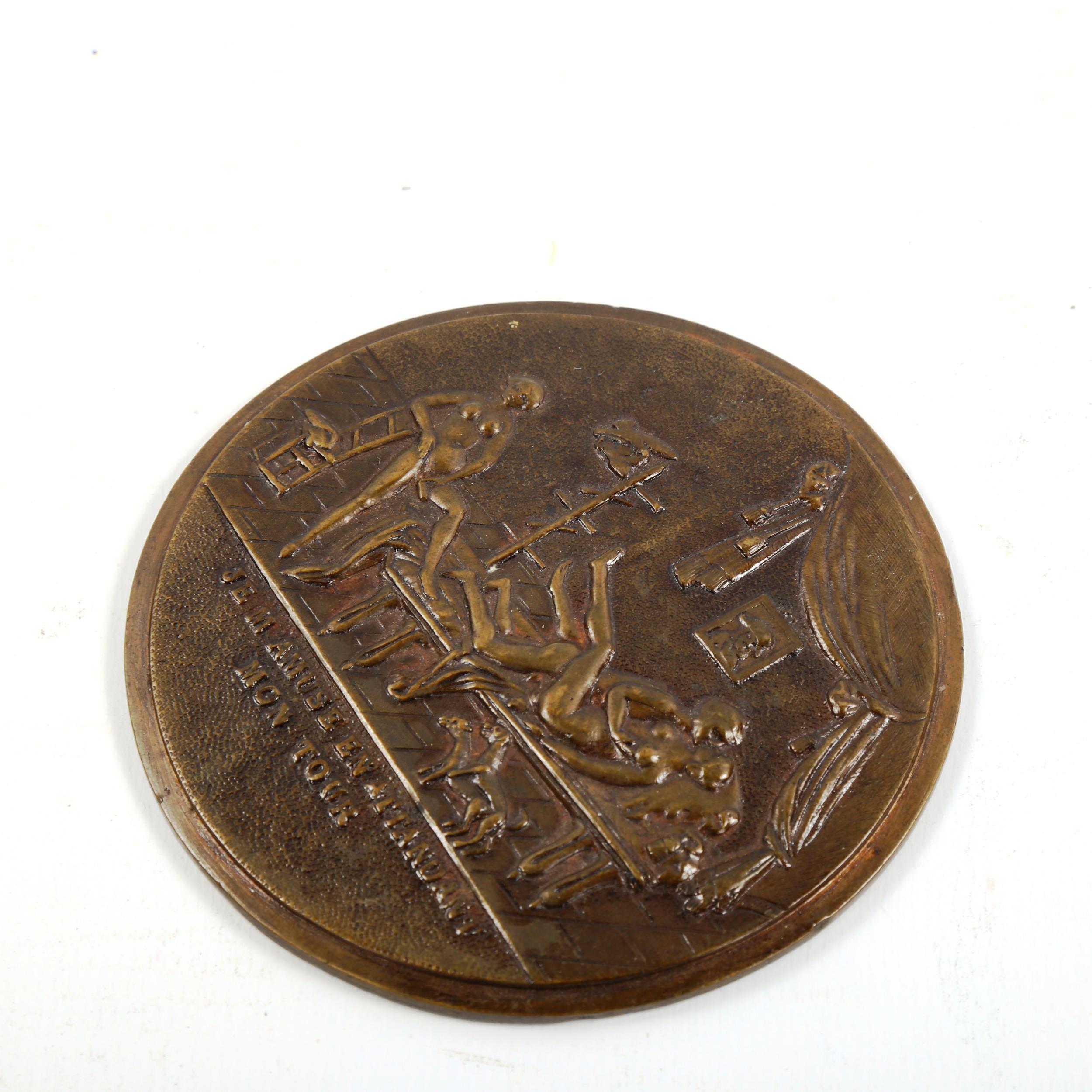 A relief cast bronze erotic plaque, diameter 8cm - Image 2 of 3