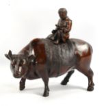 A Chinese patinated bronze incense burner figure riding a buffalo, length 17cm