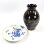 A Chinese blue and white porcelain bowl, on pine cone feet, diameter 17cm, and a black lustre