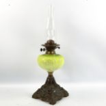 A Duplex oil lamp with moulded green glass vessel, on cast-iron base, height including shade 57cm