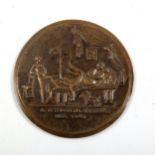 A relief cast bronze erotic plaque, diameter 8cm