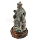 A Chinese solid cast verdigris bronze figure of an Emperor on carved wood base, height overall 22cm