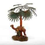 A cold painted spelter lamp in the form of camel and Arab under a palm tree, early 20th century,