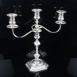 An Edwardian silver 3-light table candelabra, converting to a single candlestick with removeable