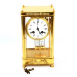 A reproduction French gilt-brass 4-glass 8-day mantel clock, Antique white enamel dial with Roman