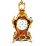 A Rococo brass-mounted faux tortoiseshell veneered 8-day mantel clock, white enamel dial with