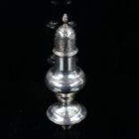 A George III silver baluster pepperette, with engraved foliate decoration and spiral finial,