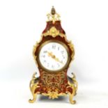 A reproduction Regency style tortoiseshell boulle inlaid mantel clock, white enamel dial with gilt-