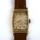 MOVADO - an Art Deci gold filled mechanical wristwatch, silvered Tonneau dial with gilt Arabic