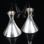 DAVID ANDERSEN - a pair of Norwegian stylised silver candlesticks, height 9cm, loaded bases No