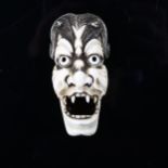 A Japanese ivory okimono, in the form of a Noh mask, Meiji Period, circa 1900, length 7.5cm
