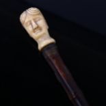 An 18th century carved ivory figural head bamboo walking cane, length 91cm