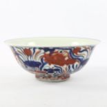 A Chinese Doucai porcelain bowl, the interior painted with fruit, the exterior painted with fish,