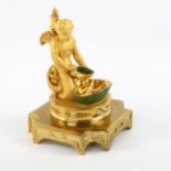 A Continental gilded porcelain posy holder, in the form of Eros holding a shell, having a stopper