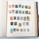 Schaubeks Briefmarken stamp album, half leather-bound, containing world postage stamps