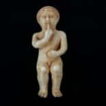 A miniature Goanese 18th century carved ivory figure of the Infant Christ, length 6cm