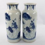A pair of Chinese blue and white porcelain cylinder vases, hand painted scenes with text