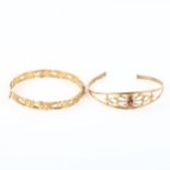 A 9ct gold garnet set cuff bangle, and a 9ct gold hinged acanthus scroll design bangle (2), 14.6g