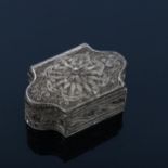 A small Continental unmarked white metal filigree spice box, of shaped rectangular form with