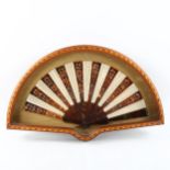 An early 20th century tortoiseshell and silk fan, in inlaid mahogany fan-shaped display case, case