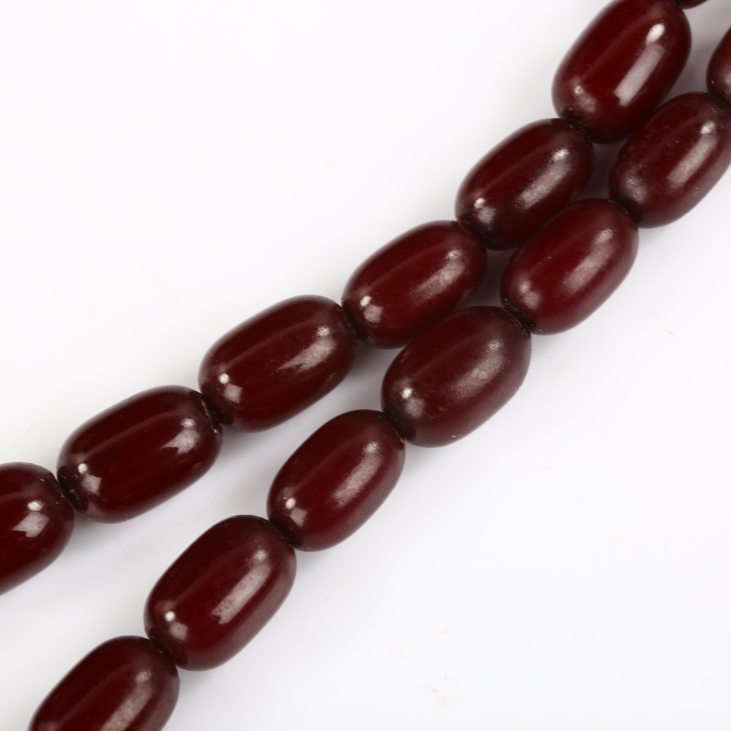 A single-strand graduated cherry amber bead necklace, bead lengths 11.5mm - 32.4mm, necklace - Image 3 of 4