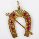 A 9ct gold ruby horse racing pendant, modelled as a horseshoe and riding crop, pendant height